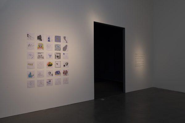 A six-by-five grid of square drawings next to a tall black rectangular doorway