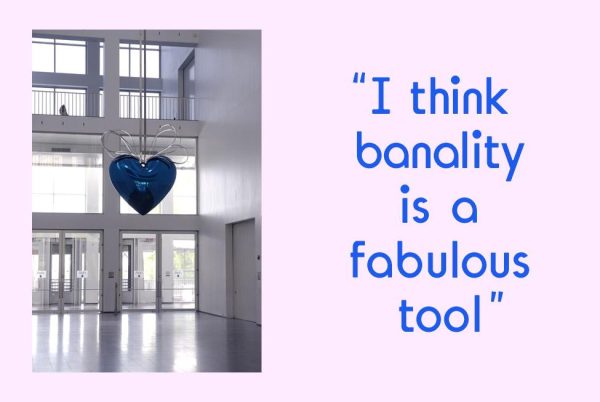 A pink rectangle with an image of a blue heart hanging in a two-story room filled with windows. Blue text accompanies the image; it reads: I think banality is a fabulous tool.