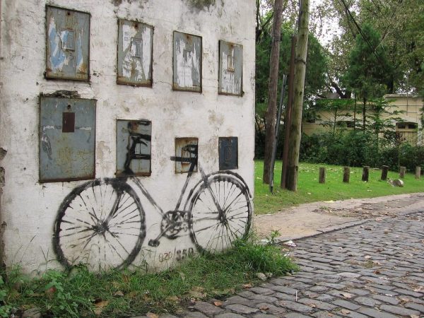 Painted bicycle on a boarded-up building