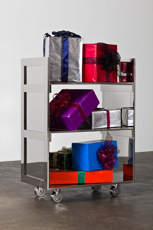 A three-tiered silver metallic cart holds colorfully wrapped gift boxes with bows.