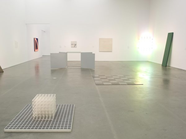 Minimalist paintings and sculptures on display in a gallery