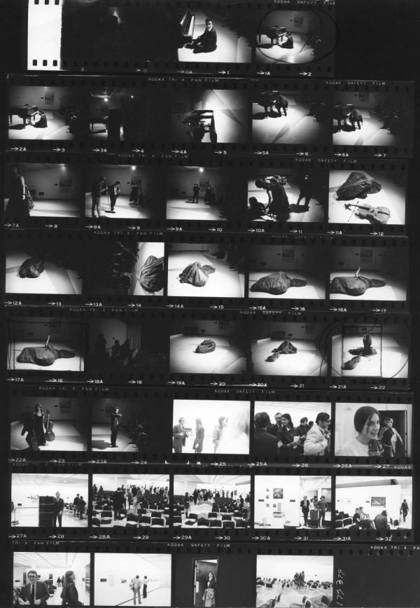Additional images of Charlotte Moorman and Nam June Paik presenting a performance art piece at the Art by Telephone opening. This contact sheet includes early MCA staff members like director Jan van der Marck and curator David Katzive.