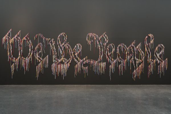 A multi-colored outline of Gothic-style letters spelling