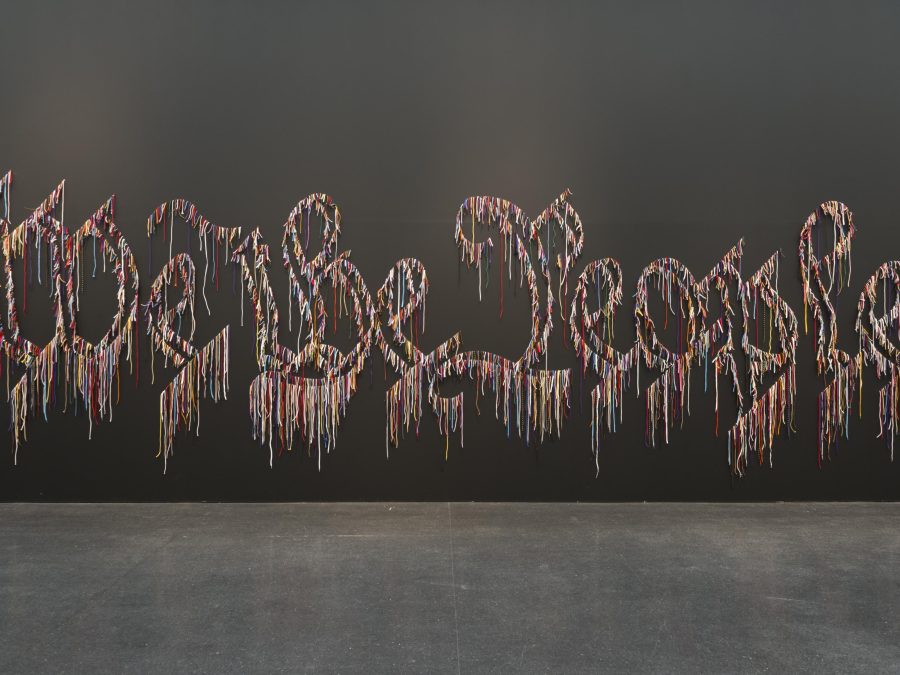 A multi-colored outline of Gothic-style letters spelling