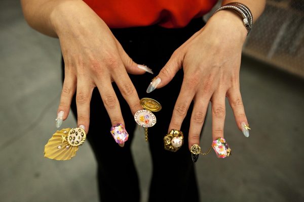 A set of hands with fingers splayed to reveal each intricate design and accessory adorning each fingernail