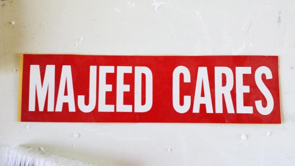 A red bumper sticker with white text that reads 