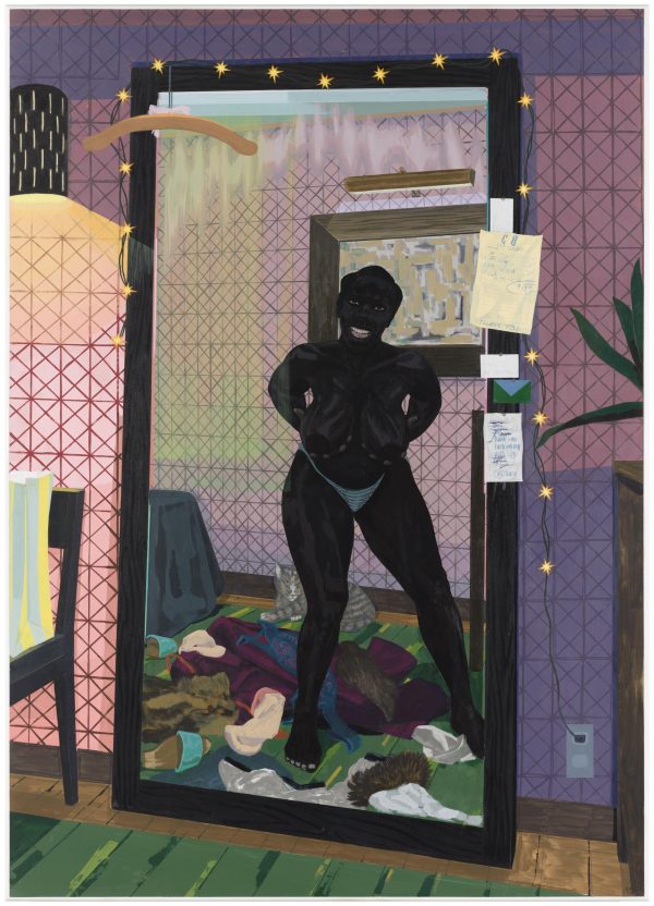A woman stands mostly nude in front of a mirror surrounded by discarded clothing. She holds her breasts in her hands as a large grin spreads across her face.