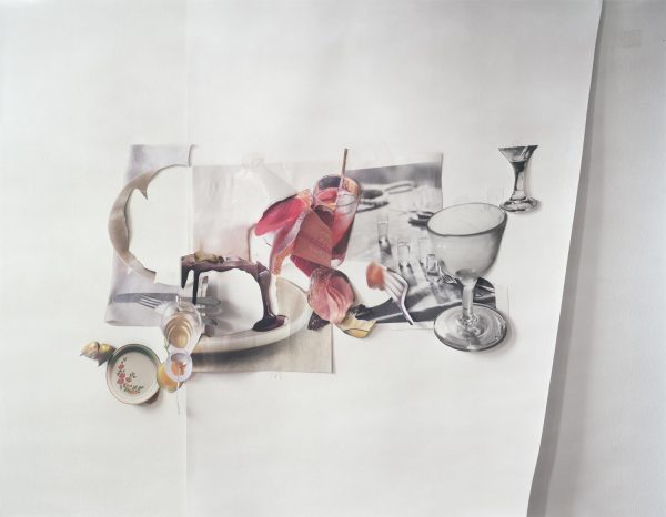 Cutouts of glasses, silverware, and plates of food form a place setting on a sheet of white paper