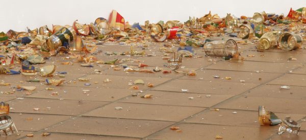 Colorful pieces of broken glass on a brown tile floor