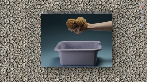 A hand squeezing a sponge into a grey pan appears in a rectangle on top of a highly textured beige surface