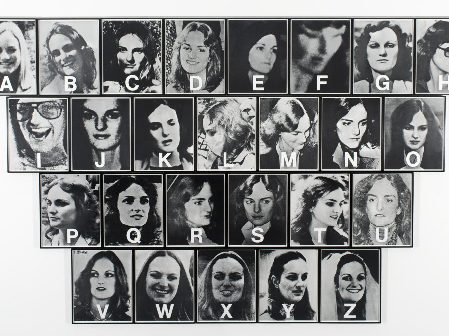 Twenty six black-and-white photographs of Patricia Hearst in four rows, with a letter of the alphabet—from A to Z—in white superimposed over each one.