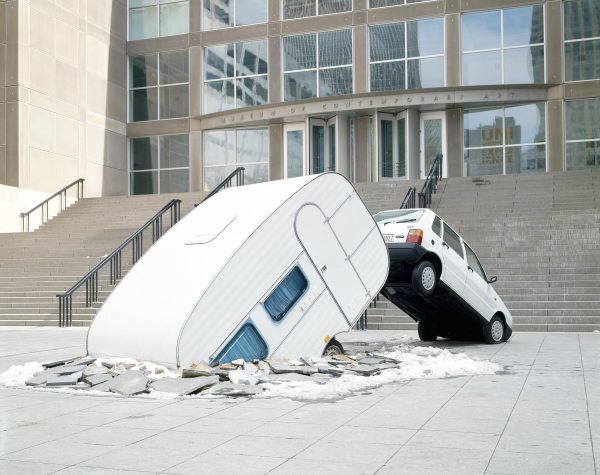 A white car and camper appear to have broken through the plaza in front of the MCA