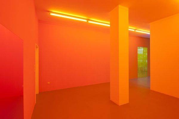 A room painted with a row of orange fluorescent lights