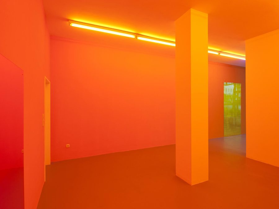 A room painted with a row of orange fluorescent lights