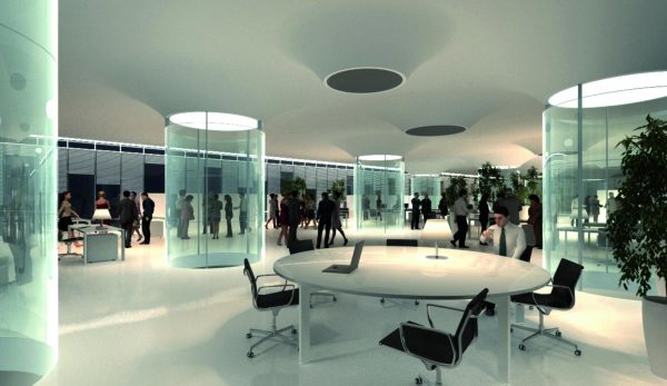 Clear greenish columns open to skylights in a futuristic space filled with office chairs around white circular tables