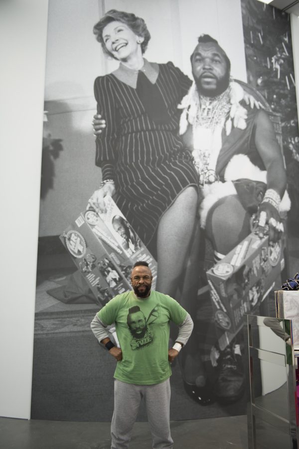 Mr. T in front of a large black-and-white photo mural of Nancy Reagan sitting on his lap