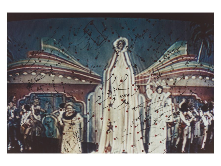 A tall, human-like form wearing white robes, is surrounded by multiple other humanoid figures Dozens of marks including arrows, dark red dots, and numbers appear to be hand-drawn over the image.