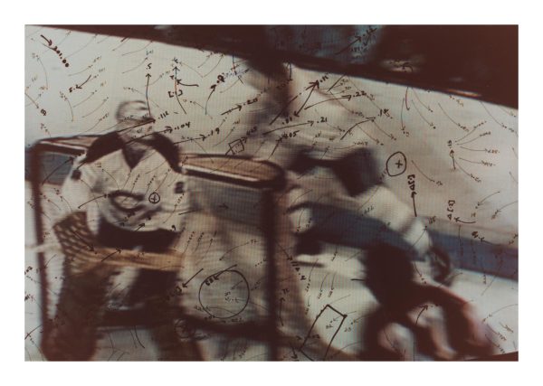 A hockey goalie defends a goal as two other players are blurred in motion behind the goal. Dozens of marks including arrows, circles, numbers, and brackets appear to be hand-drawn over the entirety of the image.