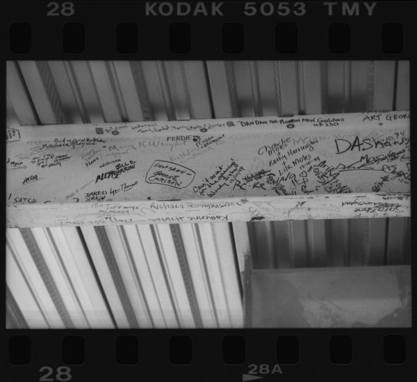 An i-beam filled with notes written in marker all over it