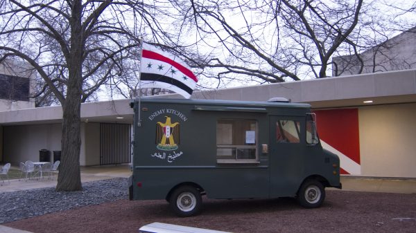 An army green food truck labeled Enemy Kitchen