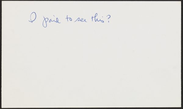 An index card with cursive text reads 