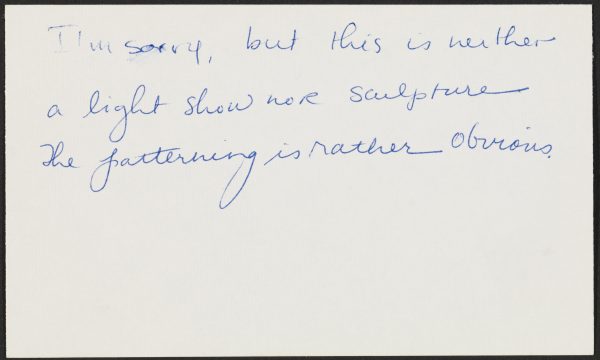An index card with handwritten text reads 