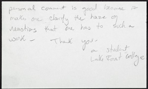 An index card with handwritten text reads 