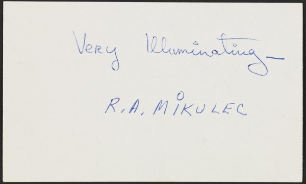 An index card with handwritten text reads 
