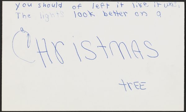 An index card with handwritten text reads 