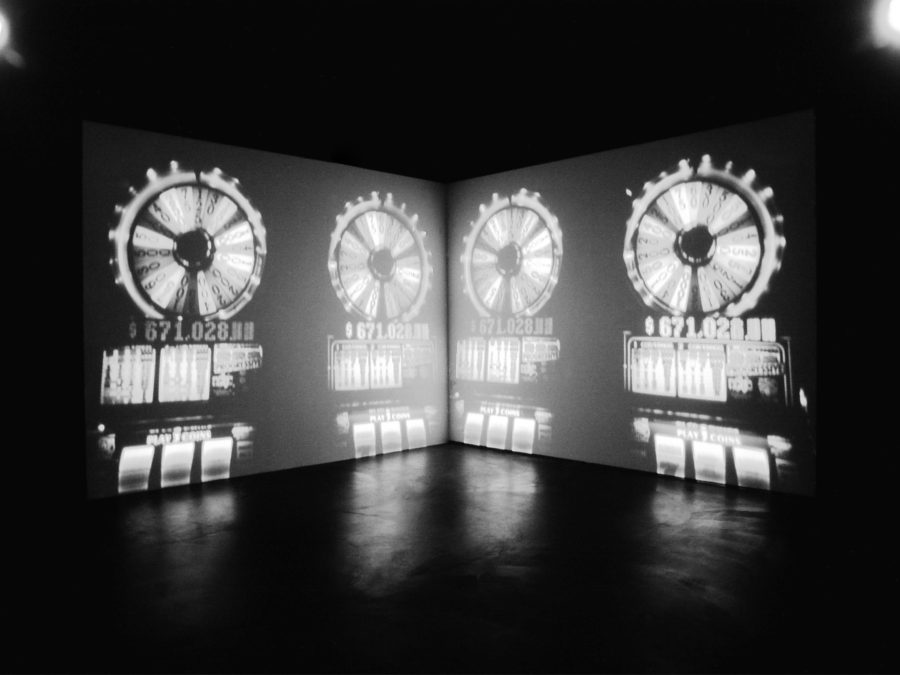 A mirrored image cast on two screens in a dark room
