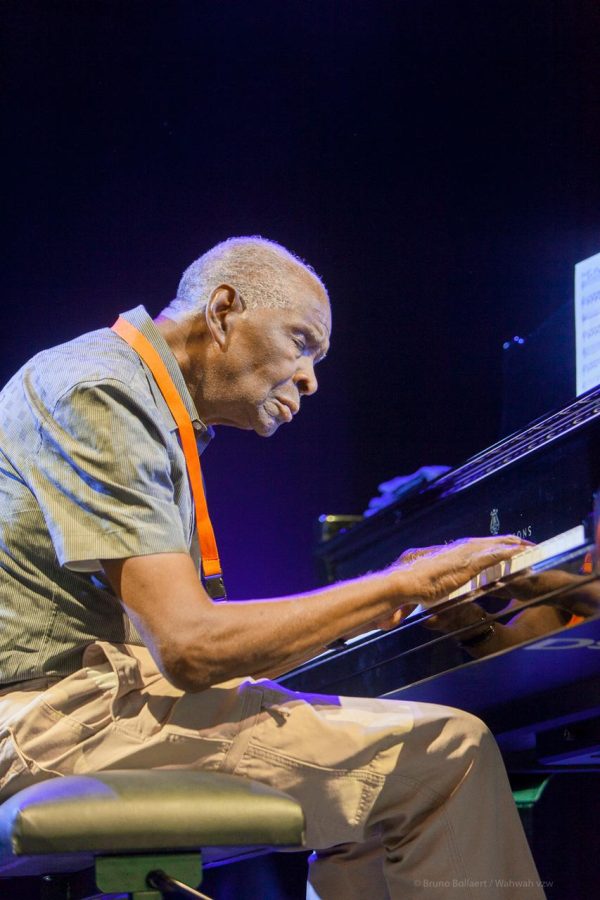 A man sits at a two-level keyboard