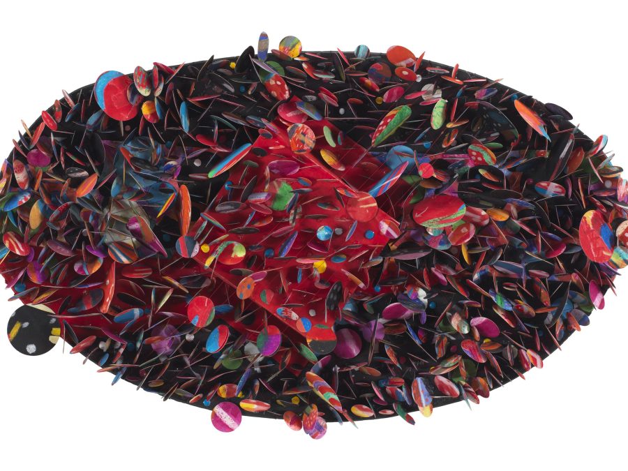 An oval composition consists of numerous colorful circles that overlap and jut out in different directions from a dark background.