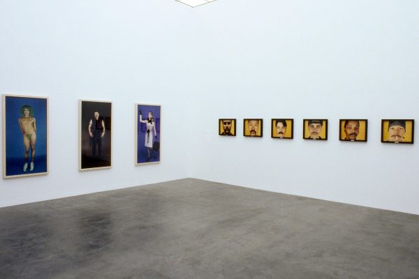 Two sets of series of artworks on adjacent white gallery walls