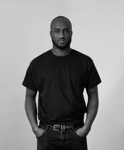 A portrait of Virgil Abloh standing, hands in pockets