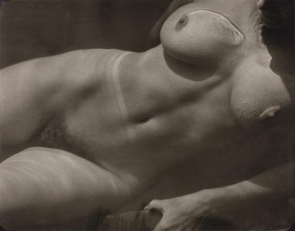 The torso of a woman submerged in water