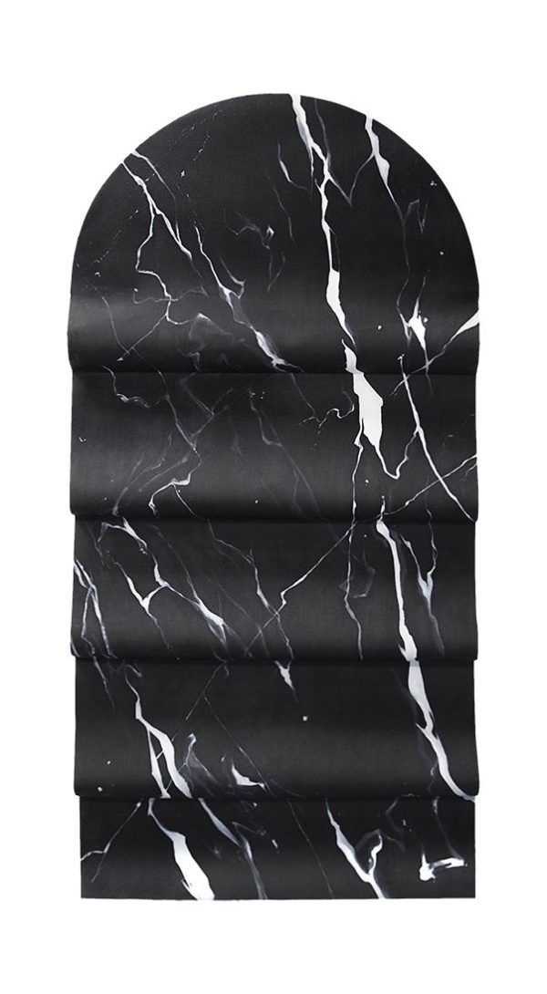 An arched object that appears like black marble with white striations through it and four folded tiers resembling a window shade