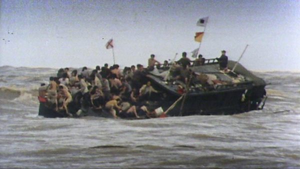 A large group of people on a capsizing boat