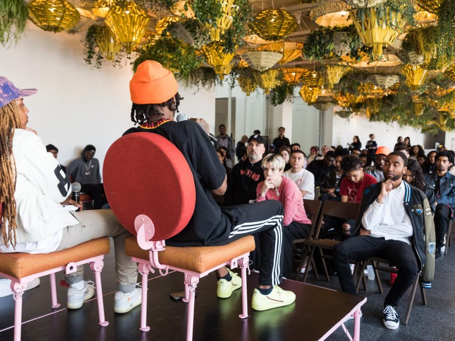 panel speakers look out on a full seated audience in the MCA commons gallery