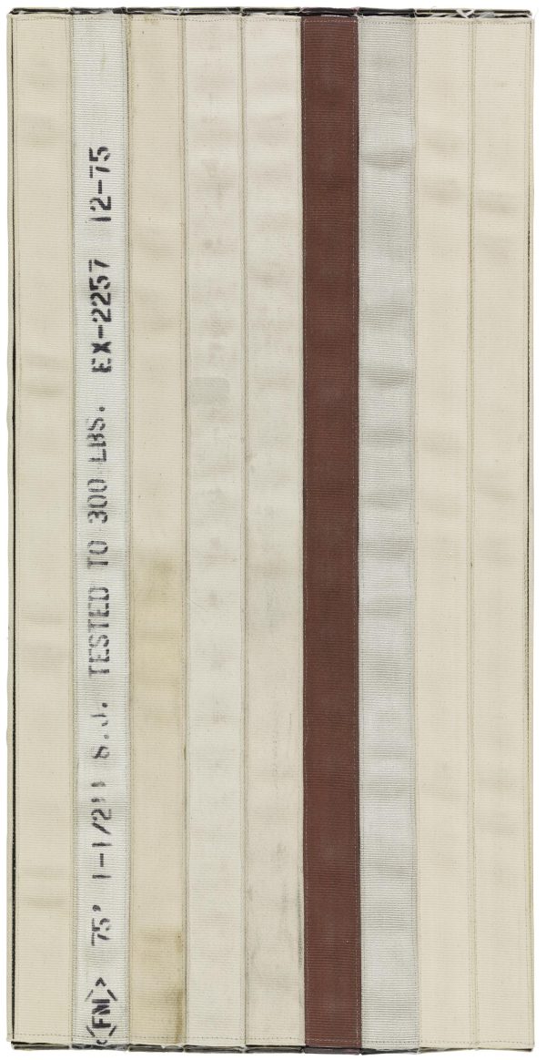 A vertically oriented artwork appears to consist of seatbelt-like strips of fabric stitched together. One strip shows black text including 