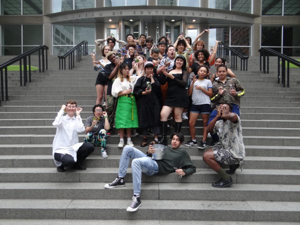 A group of people pose on steps leading up to the Museum of Contemporary Art Chicago