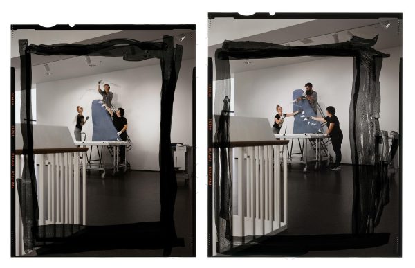 Two photos of people hanging a mobile in a gallery altered with black paint forming squares around the action.