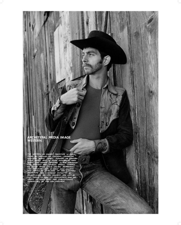 A man with a mustache leans against a wooden wall; his left hand rests slightly down his pants. He wears a cowboy hat, a Western shirt, jeans, and a belt with a large buckle. The image is labeled Archetypal Media Image Western.