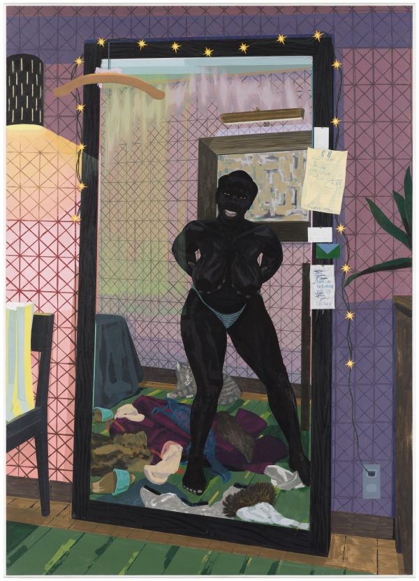 A woman stands mostly nude in front of a mirror surrounded by discarded clothing. She holds her breasts in her hands as a large grin spreads across her face.