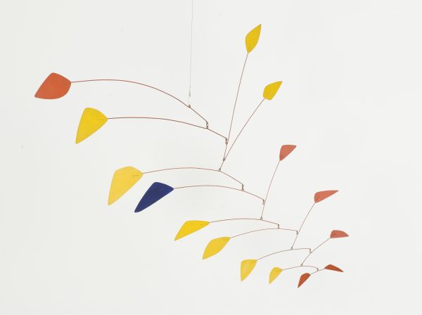 A multi-tiered mobile featuring hanging elements in orange and yellow, and one blue triangle.