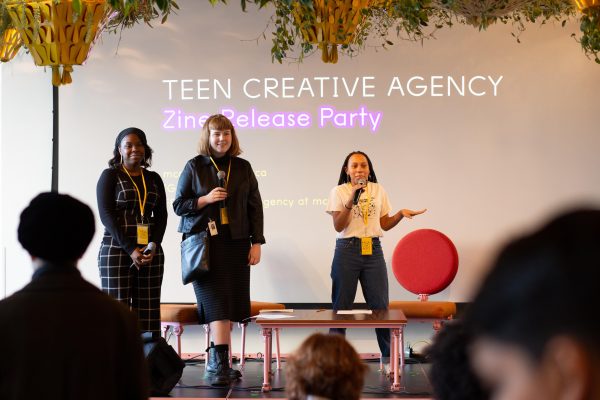 three women with microphones lead presentation