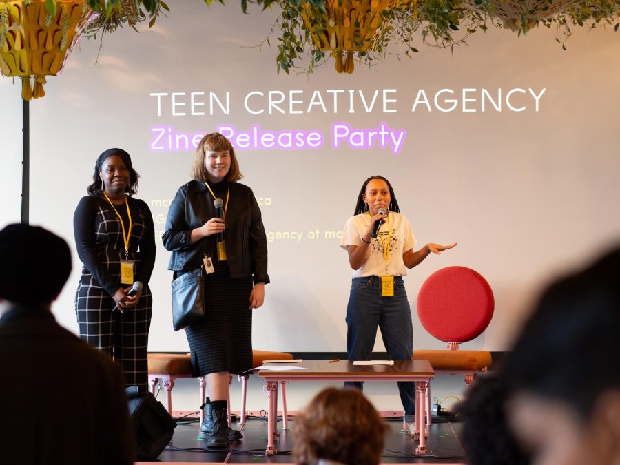 three women with microphones lead presentation