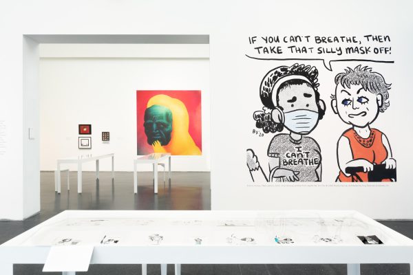 Exhibition interior with comic artwork on walls
