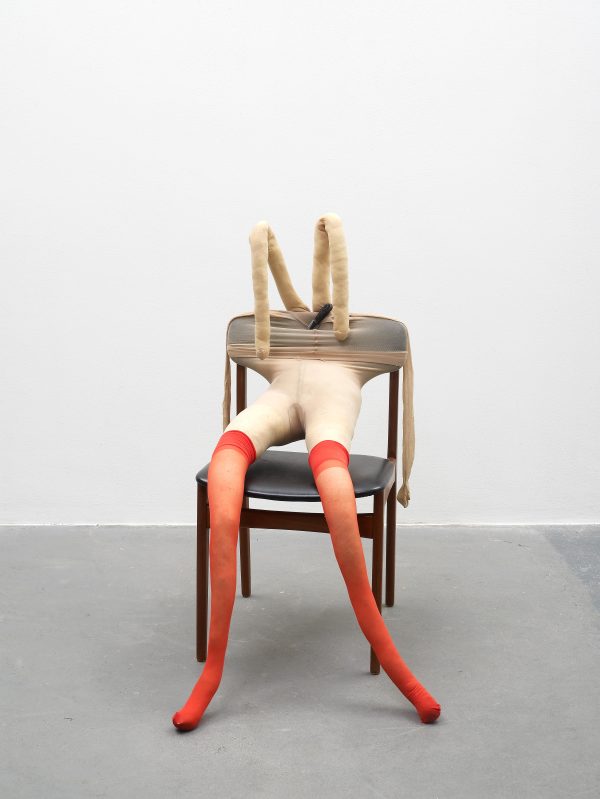 sculpture of figure on chair